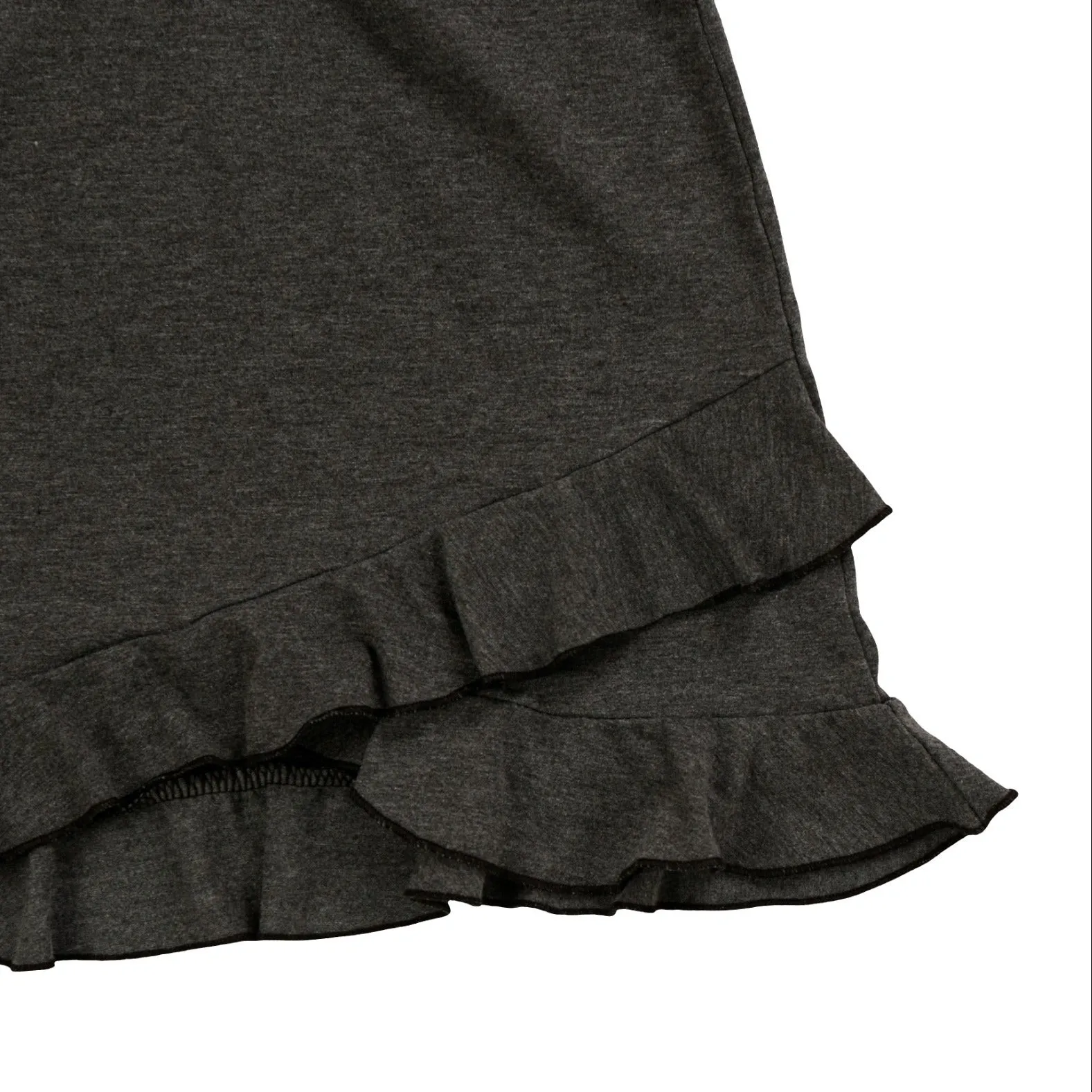 Close-up of the charcoal tank's asymmetric double ruffle hem and overlock seams